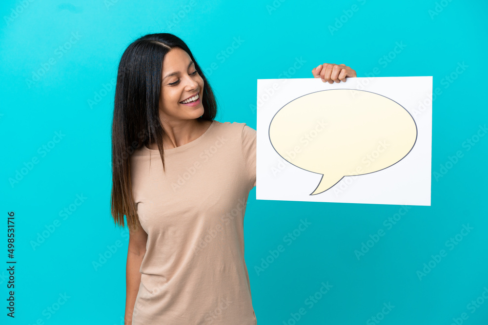 Young woman over isolated background holding a placard with speech bubble icon Young woman over isolated background holding a placard with speech bubble icon