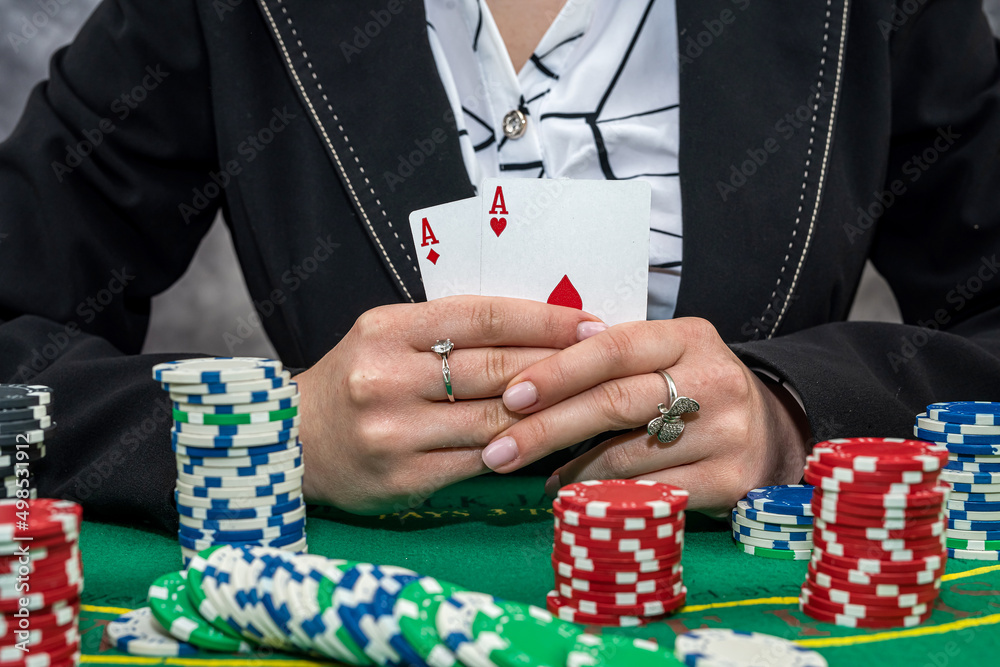 Woman in suit playing poker with cards and chips Woman in suit playing poker with cards and chips