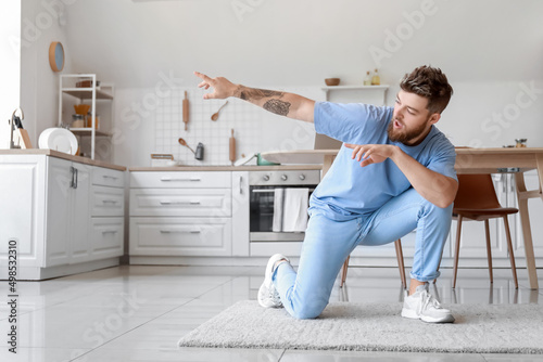Cool young man dancing at home