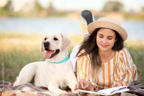 Woman with cute Labrador re...