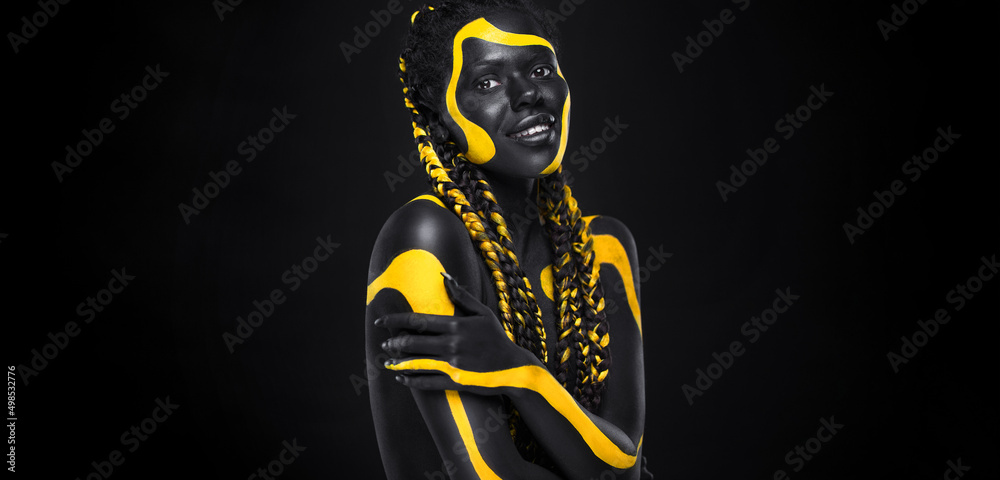 Yellow and black body paint. Woman with face art. Young girl with