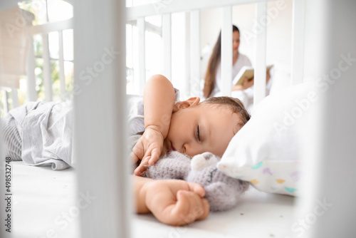 Wallpaper Mural Adorable baby with toy sleeping in crib, closeup Torontodigital.ca