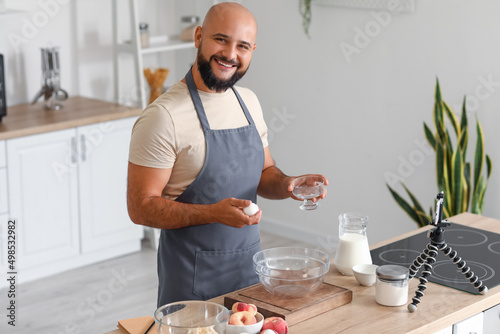 Handsome man cooking with v...