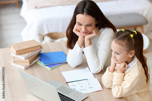 Cute girl studying with tut...