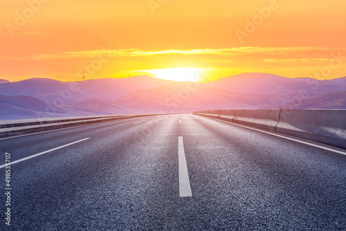 Asphalt road and mountain with beautiful sky clouds at sunrise © ABCDstock