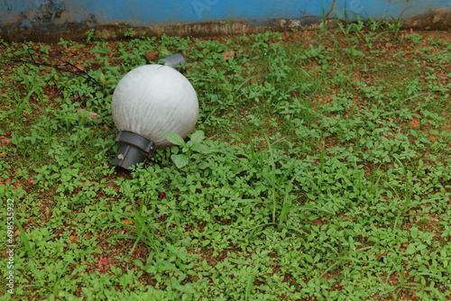 broken garden light on grass