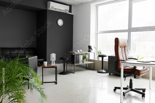 Modern office with stylish furniture and big window