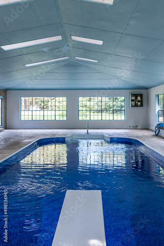 Large indoor pool with lots of natural light from large windows in an atrium