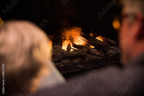 Romantic couple relaxing in front of the fireplace. . High quality photo