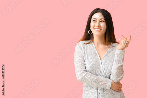 Smiling Asian woman with gl...