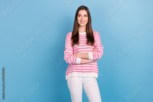 Portrait of minded smart person folded hands look interested empty space isolated on blue color background