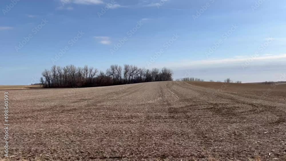 A countryside view through moving car showing barren land of southwest Minnesota. USA.