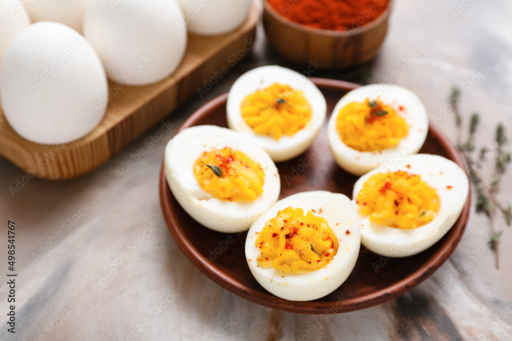 Plate, holder with eggs and paprika on grunge background, closeup. Easter celebration Plate, holder with eggs and paprika on grunge background, closeup. Easter celebration
