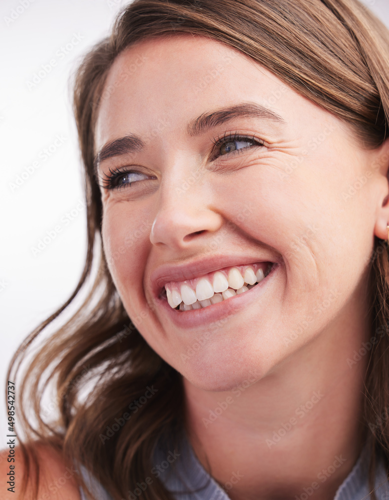 Her smile simply lights up the room. Closeup shot of a cheerful young woman looking thoughtful against a white background. Her smile simply lights up the room. Closeup shot of a cheerful young woman looking thoughtful against a white background.