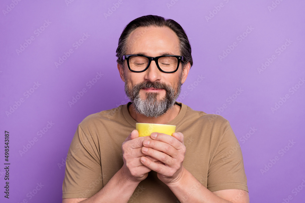 Portrait of handsome dreaming peaceful man feel nice smell of yummy coffee with closed eyes isolated on violet color background Portrait of handsome dreaming peaceful man feel nice smell of yummy coffee with closed eyes isolated on violet color background