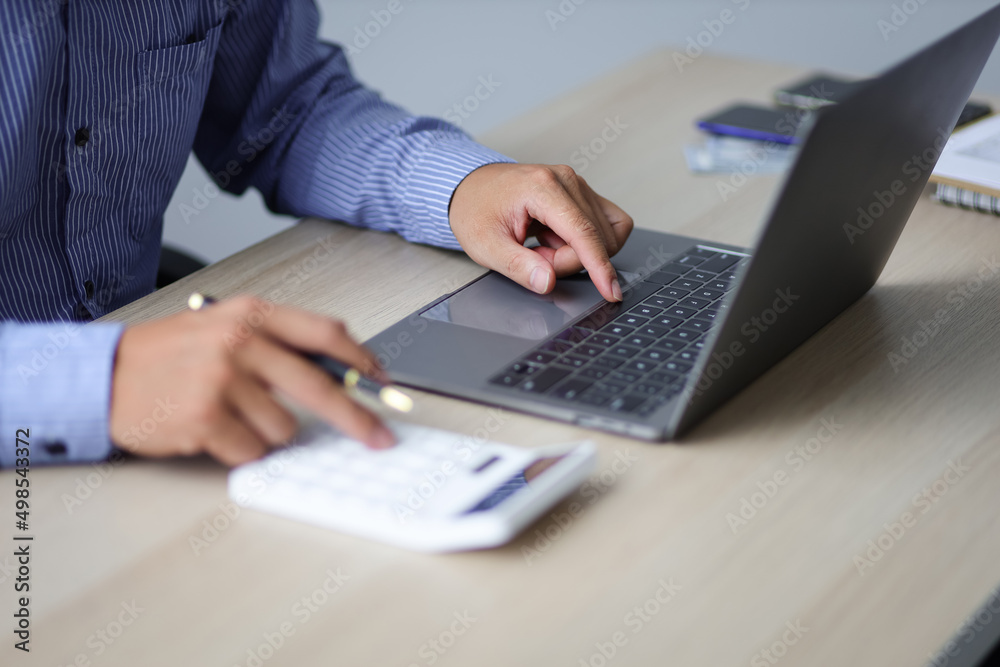 Businessmen are calculating income-expenditure and analyzing digital assets investment data. Accounting Financial and tax systems concept. Businessmen are calculating income-expenditure and analyzing digital assets investment data. Accounting Financial and tax systems concept.