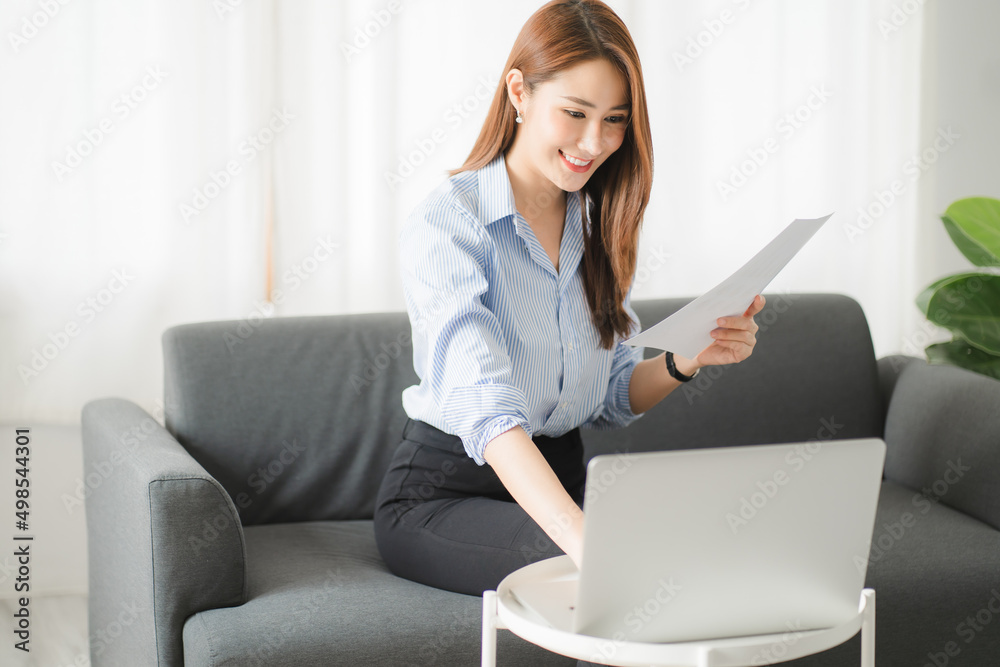 Portraits of beautiful smiling Asian women relax using laptop computer technology while sitting on their desks and using their creativity to work, work from home concept. Portraits of beautiful smiling Asian women relax using laptop computer technology while sitting on their desks and using their creativity to work, work from home concept.