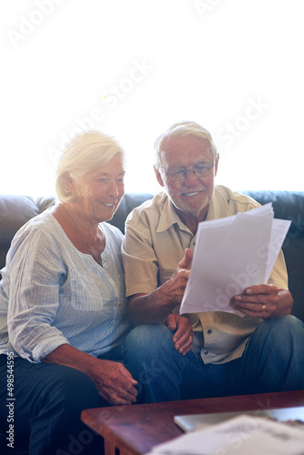 Looks like were living within our means. Shot of a senior couple going through their paperwork together at home.