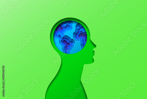 Green paper cut man head illustration with earth world map globe inside. Modern 3D papercut craft people profile silhouette design for nature care concept, or eco friendly project.