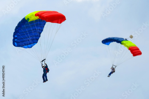 Two parachutists ready to land - skydiving