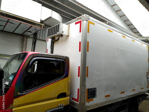 Logistics truck car with cooler box in industrial area.