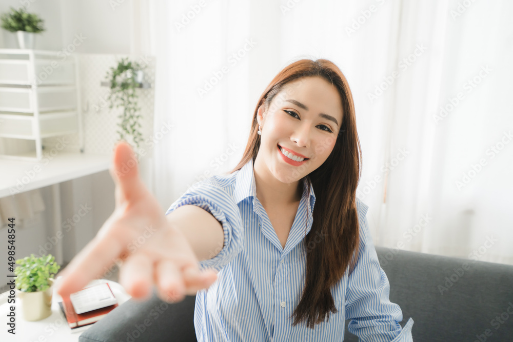 Portraits of beautiful smiling Asian women relax using laptop computer technology while sitting on their desks and using their creativity to work, work from home concept.