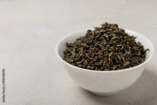Green tea in a white ceramic bowl on a light background. tea for immunity and detox. place for text. Tea ceremony.