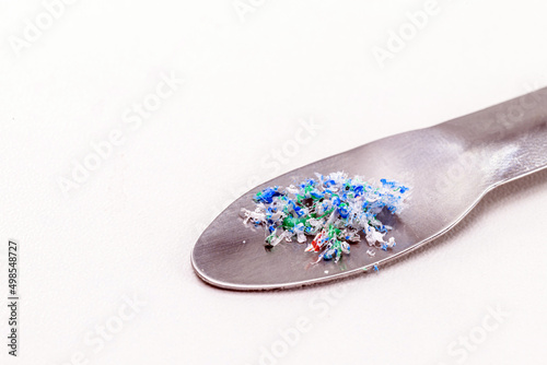 metal spatula with traces of micro plastic taken from the ocean, pollutant, polymers, being analyzed. Copy Space