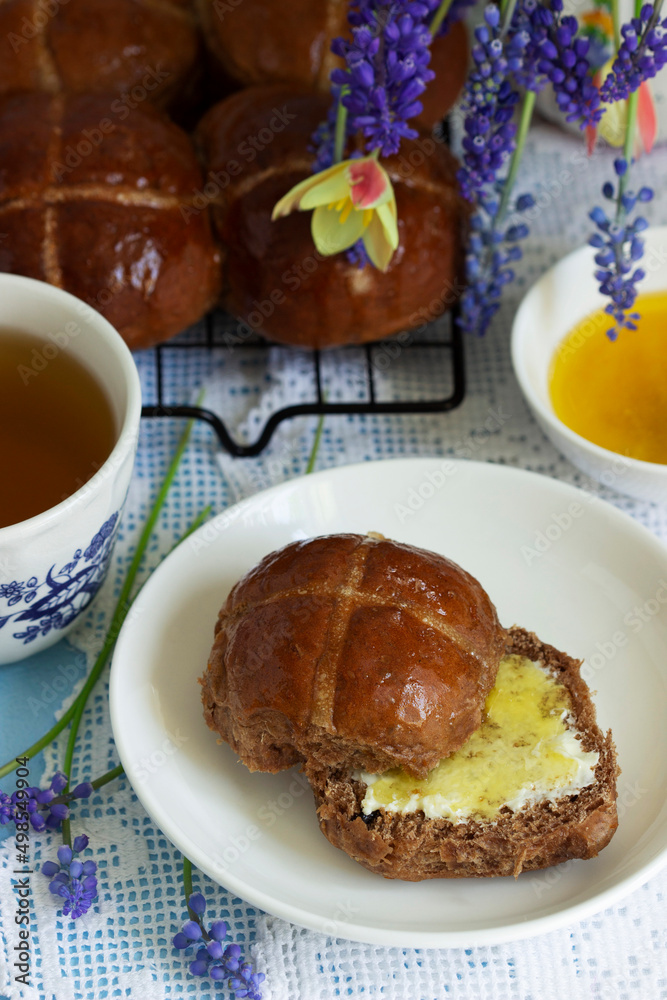 Chocolate cross buns served with butter and honey. Traditional Easter baking.