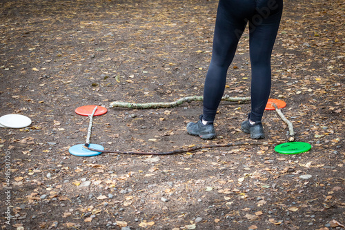 person playing disc golf putting game in oark photo