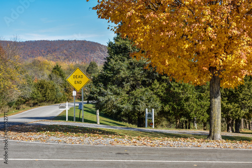 Dead End Sign in Cheerful Fall Landscape photo