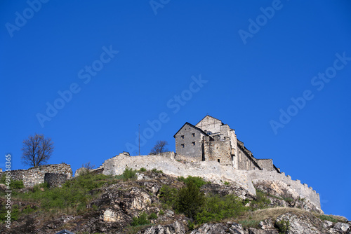 Beautiful medieval catholic church and castle Basilique de Valère (Valeria) on a hill at City of Sion on a sunny spring day. Photo taken April 4th, 2022, Sion, Switzerland.