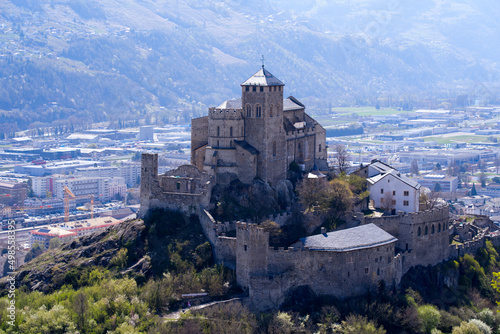 Beautiful medieval catholic church and castle Basilique de Valère (Valeria) on a hill at City of Sion on a sunny spring day. Photo taken April 4th, 2022, Sion, Switzerland. photo