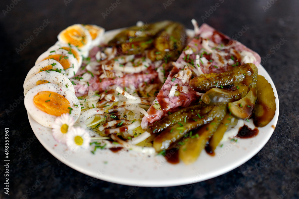 ready to eat - brawn with pickles, boiled egg, onions, balsamic vinegar, chives and daisy decor