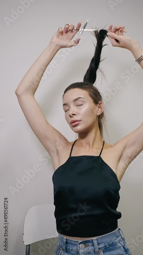 Girl with scissors in a hairdressing salon