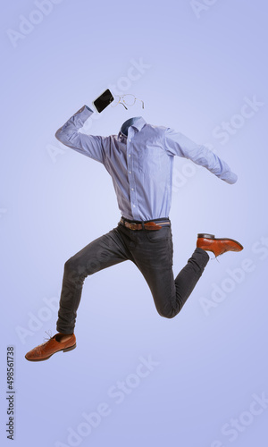 Portrait of invisible man wearing modern business style outfit running and talking on phone against blue background. Concept of fashion, creativity