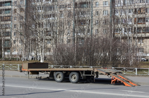 Obraz na plátně A trailer for transporting vehicles is parked on the street, Badaeva Street, St