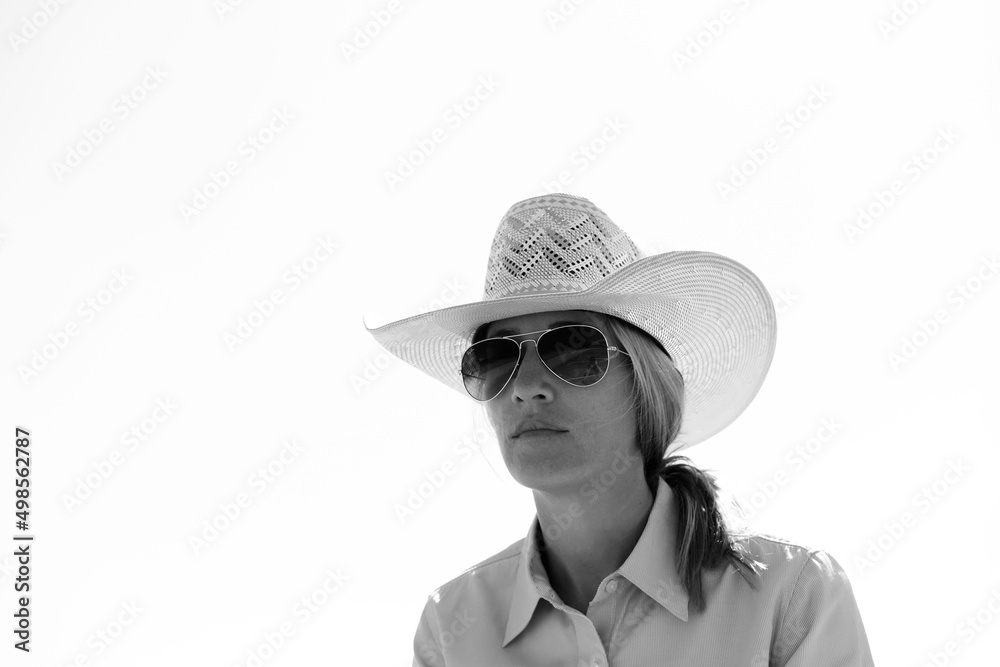 Western lifestyle portrait shows cowgirl isolated on white background with copy space. Western lifestyle portrait shows cowgirl isolated on white background with copy space.
