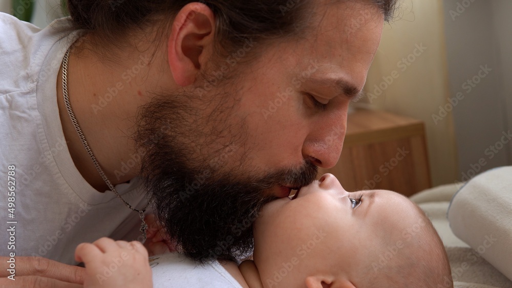 Authentic Young Bearded Man Holding Newborn Baby. Dad And Child Son On Bed. Close-up Portrait of Smiling Family With Infant On Hands. Happy Marriage Couple On Background. Childhood, Parenthood Concept Authentic Young Bearded Man Holding Newborn Baby. Dad And Child Son On Bed. Close-up Portrait of Smiling Family With Infant On Hands. Happy Marriage Couple On Background. Childhood, Parenthood Concept