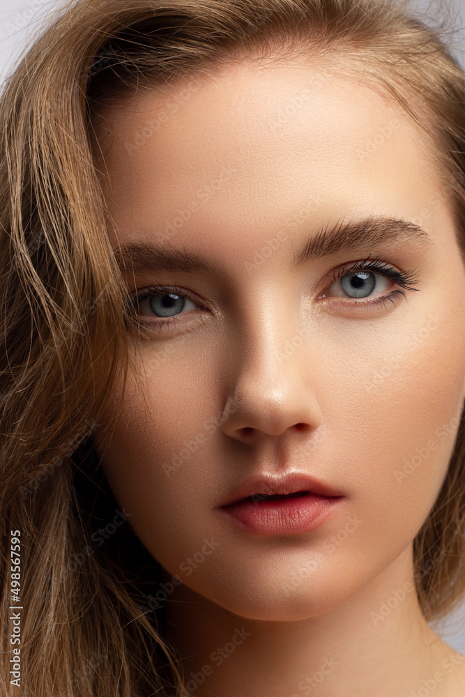 Beautiful woman with bright make up eye with sexy black liner makeup. Fashion big arrow shape on woman's eyelid. Natural lips. Chic evening make-up. Blonde long wave hair. Shining face skin Beautiful woman with bright make up eye with sexy black liner makeup. Fashion big arrow shape on woman's eyelid. Natural lips. Chic evening make-up. Blonde long wave hair. Shining face skin