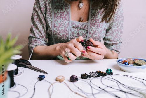 Картината върху платно Woman hands making handmade gemstone jewellery