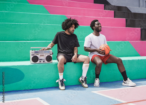 Photography Diverse african men sitting in the city while listening music from vintage stere