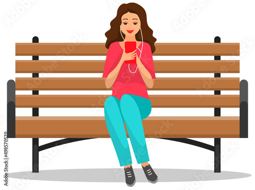 Woman sitting on bench holds smartphone in her hand. Casual lady in headpones listening to music and browsing social media on mobile device. Girl on couch uses phone for chatting and surfing internet