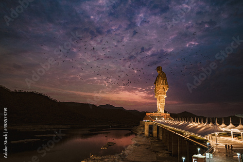 Beautiful shot of a statue of Unity in India against a cloudy sky at sunset photo