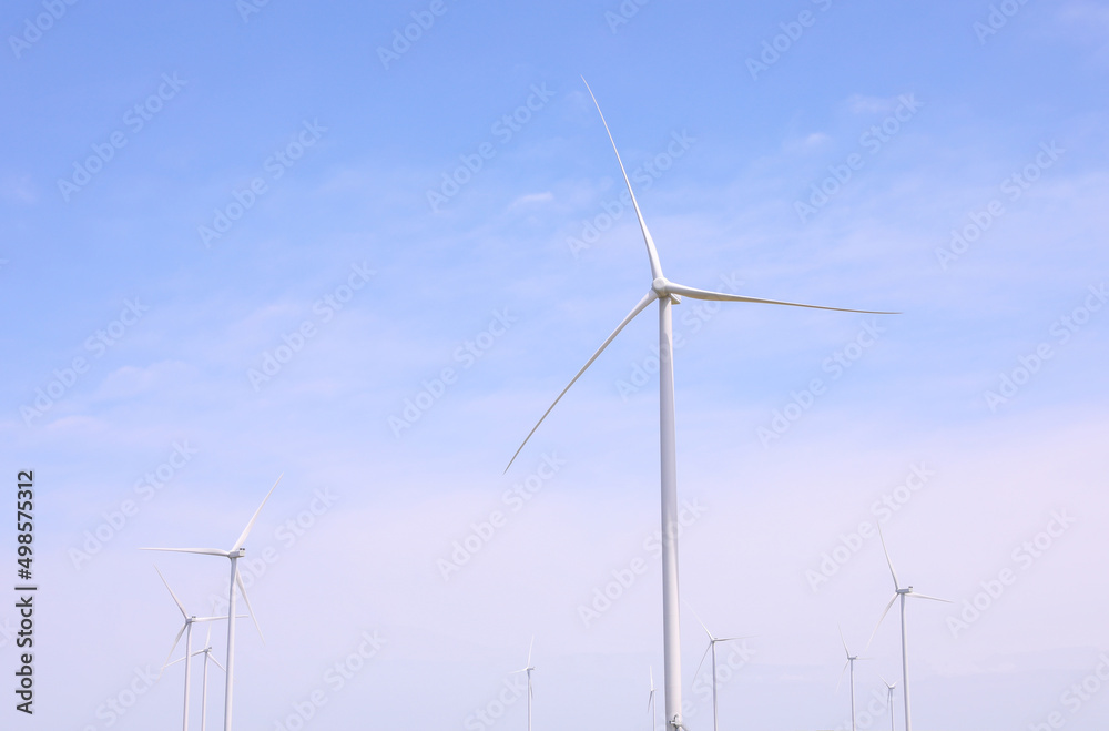 Wind turbines against the backdrop of a sunny sky. Green ecological energy generation. Eco field wind farm