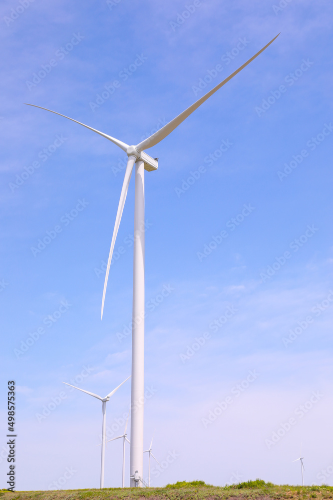 Wind turbines against the backdrop of a sunny sky. Green ecological energy generation. Eco field wind farm Wind turbines against the backdrop of a sunny sky. Green ecological energy generation. Eco field wind farm