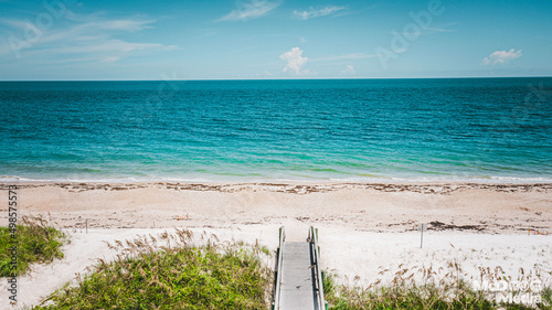 View of the sunny, sandy and tropical Vero beach and the ocean in Florida, United States photo