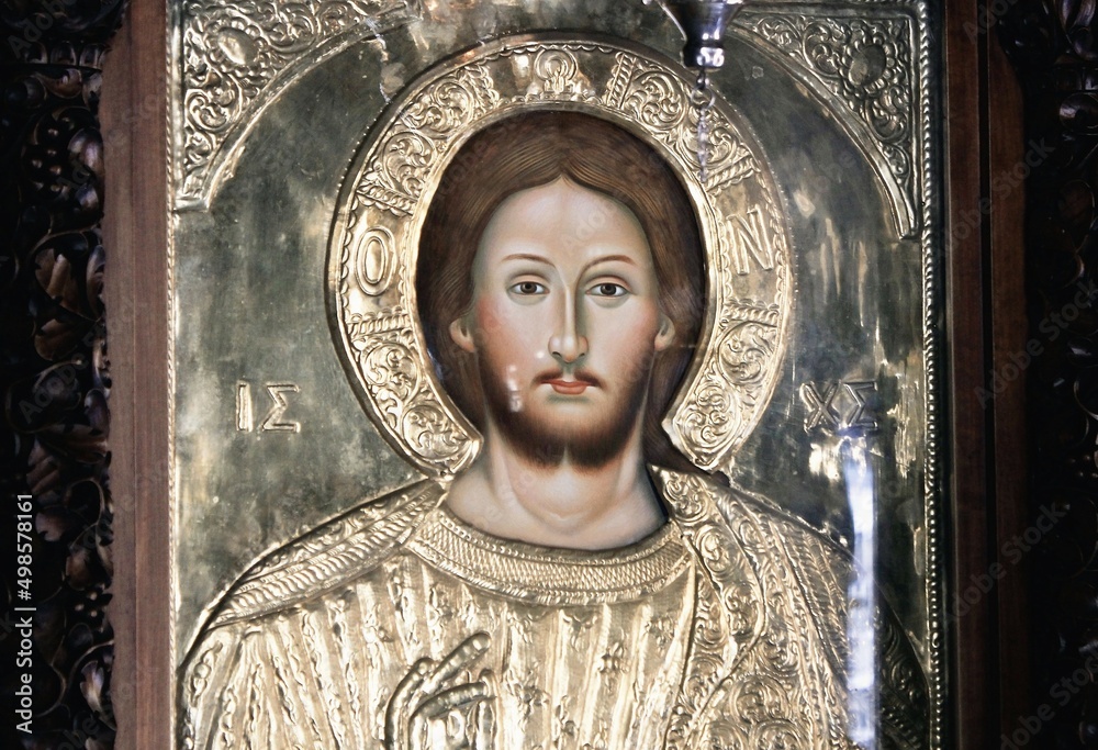Obraz premium Icon of Jesus Christ handcrafted and covered with gold inside a Christian orthodox church in Athens, Greece - August 11 2020.