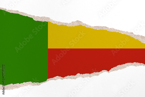 Ripped paper background in colors of national flag. Benin