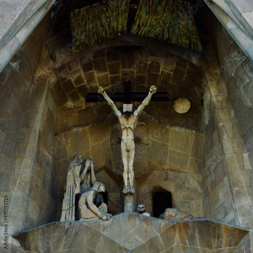 Statue of the crucified Jesus Christ on the facade of the Sagrada Familia Cathedral .Barcelona